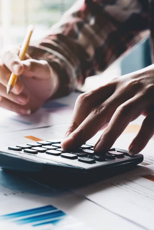 man typing on a calculator